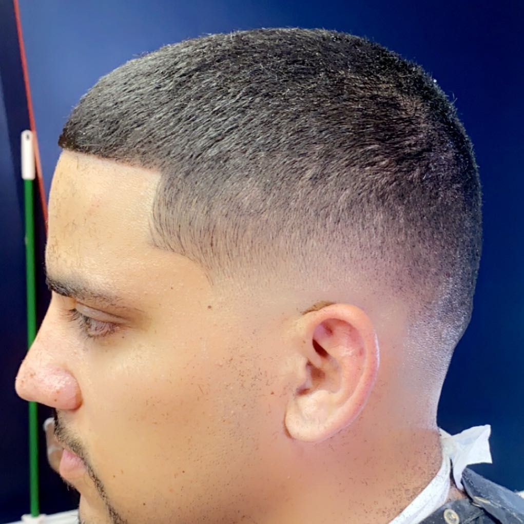 Side profile of a short cut with a low fade and sharp line-up